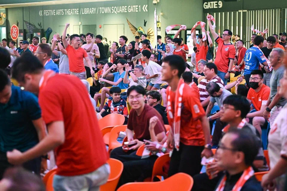 Singapore Lions players celebrating Asian Cup 2027 qualification at the National Stadium