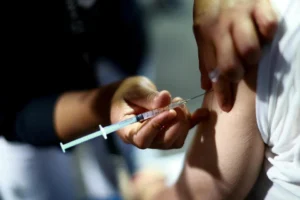 A healthcare worker preparing a vaccine dose amid Singapore’s measles precautions