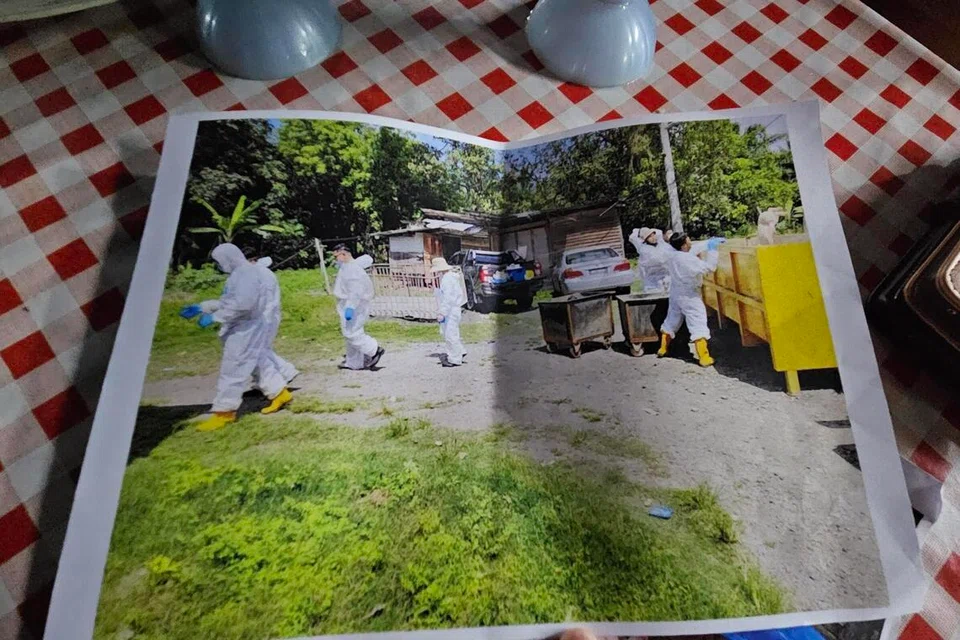 A pig farmer in Tanjung Sepat, Selangor, holding documents as farms face closure